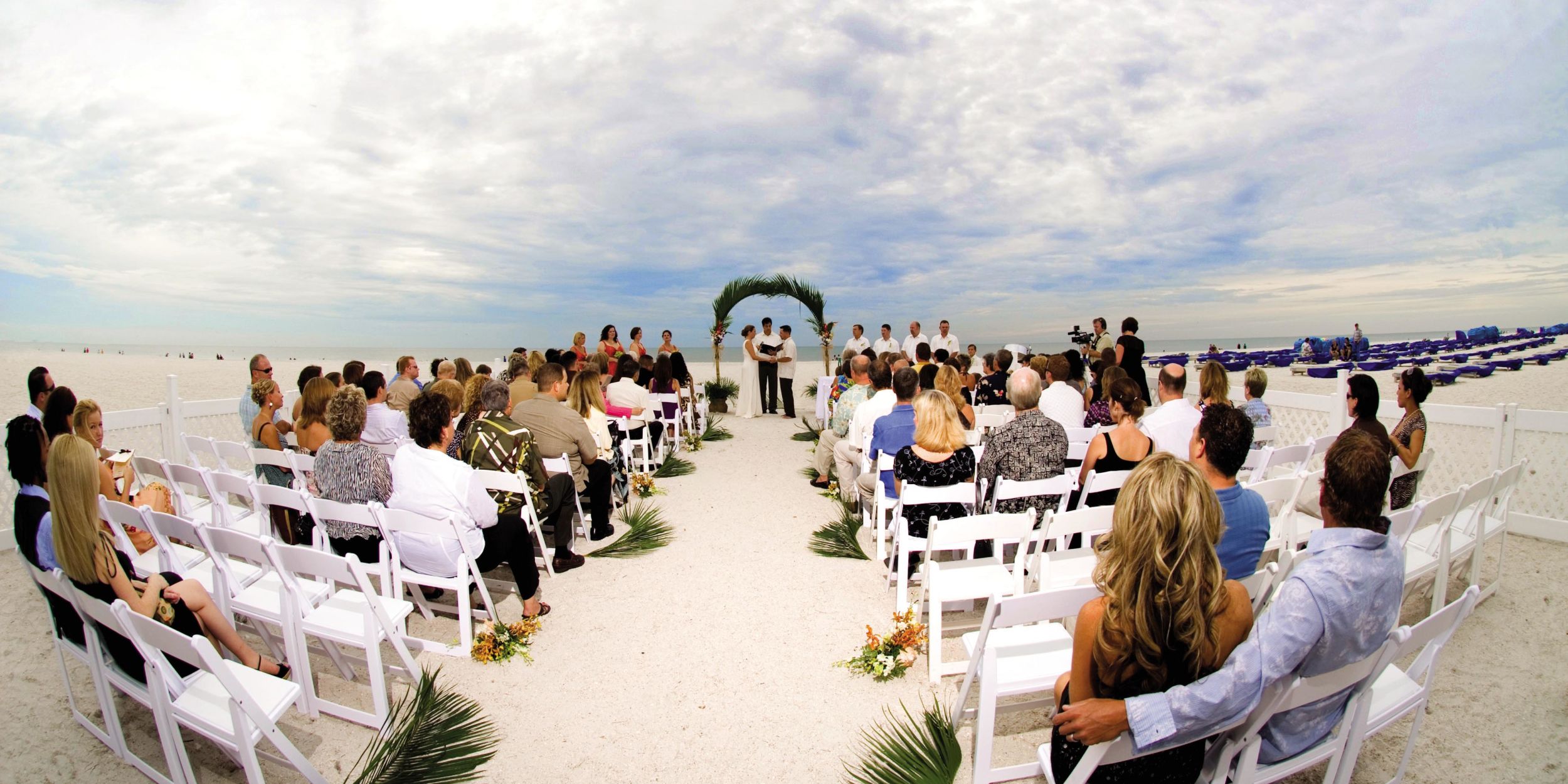 A Group Of People Sitting At A Beach
