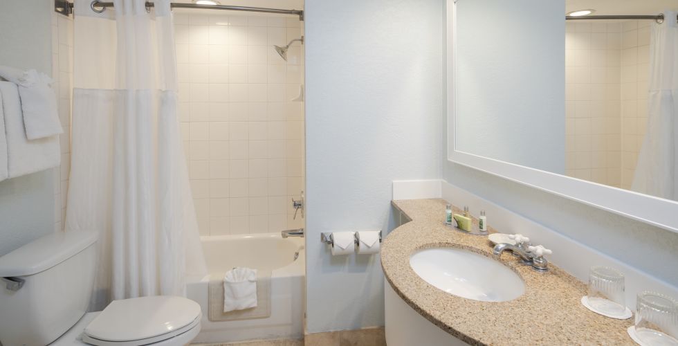 A Room With A Sink And A Mirror