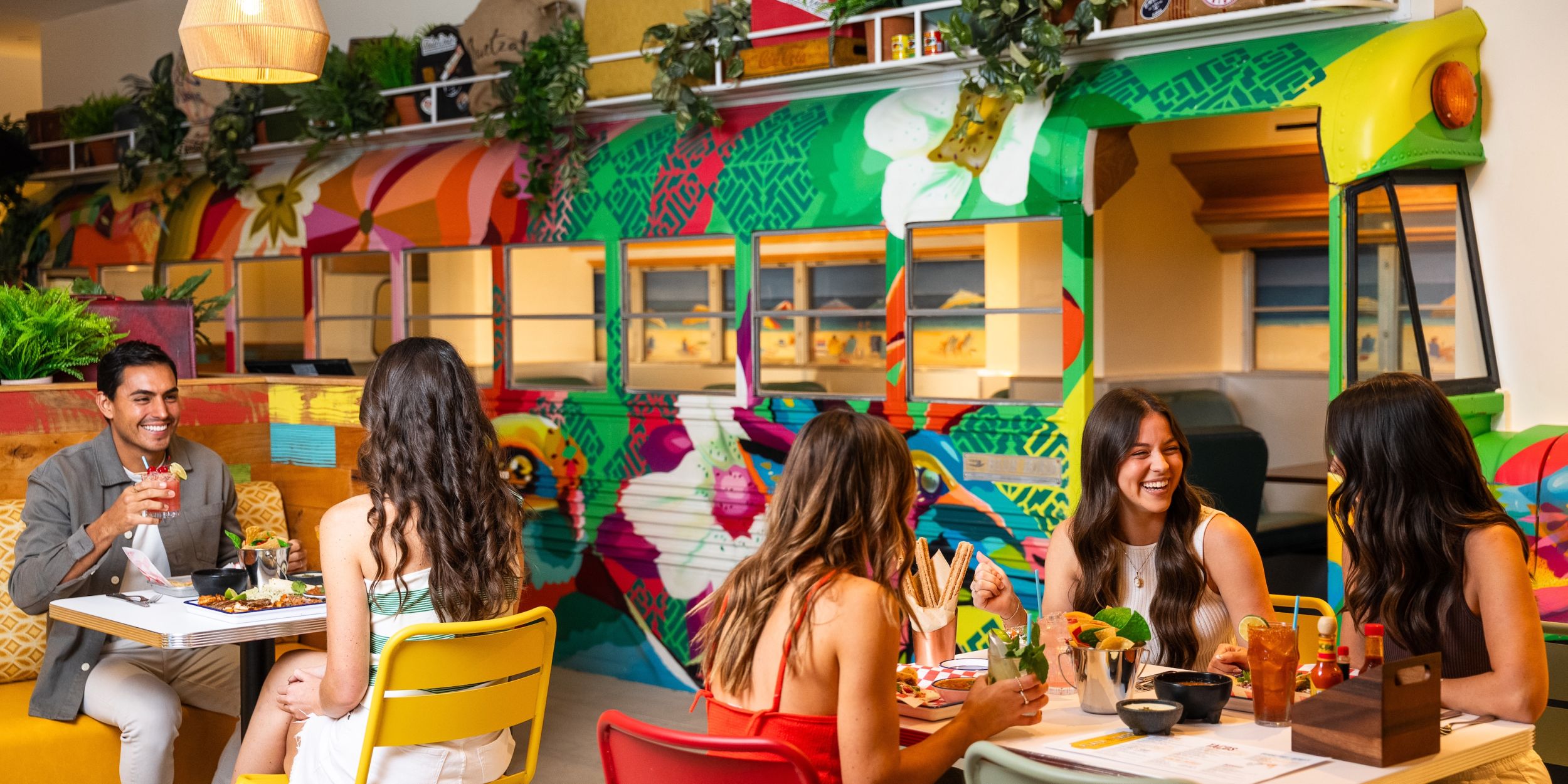 A Group Of People Sitting At A Table