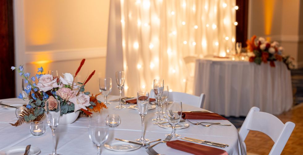 A Set Dining Table With White Tables And White Cloths