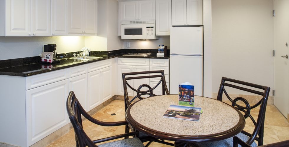 A Kitchen With A Stove Top Oven Sitting Inside Of A Room