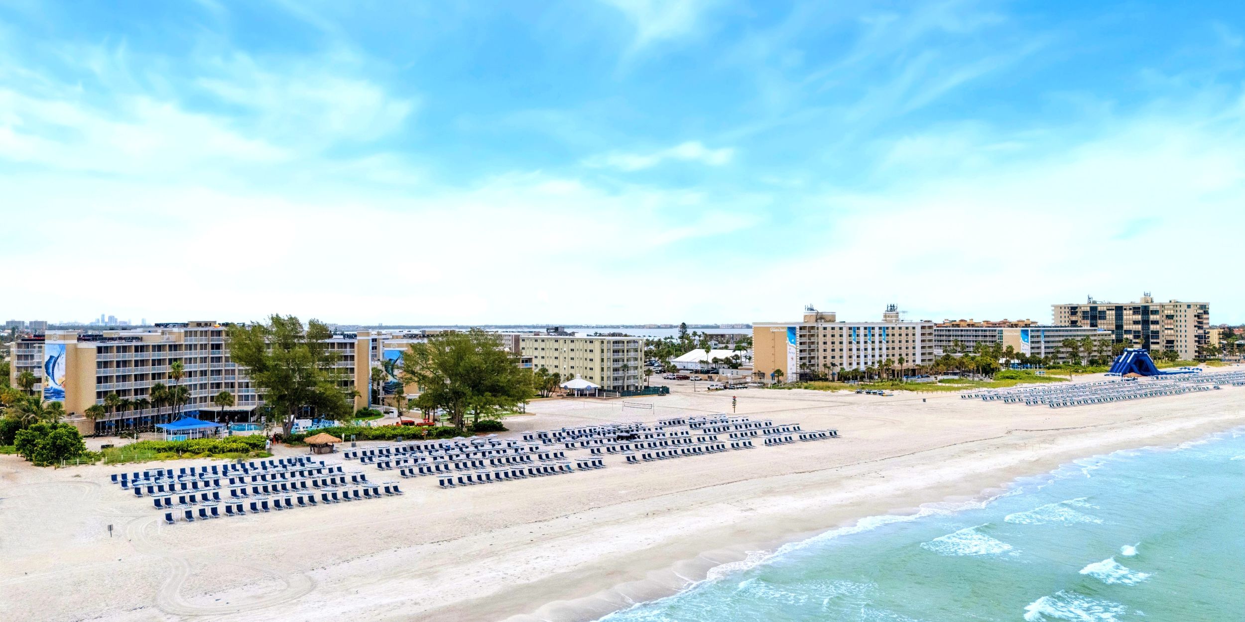 A Beach With Buildings In The Background