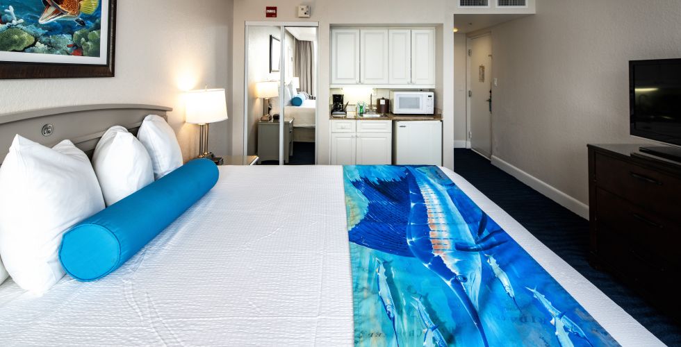 A Large Bedroom With A Blue Rug