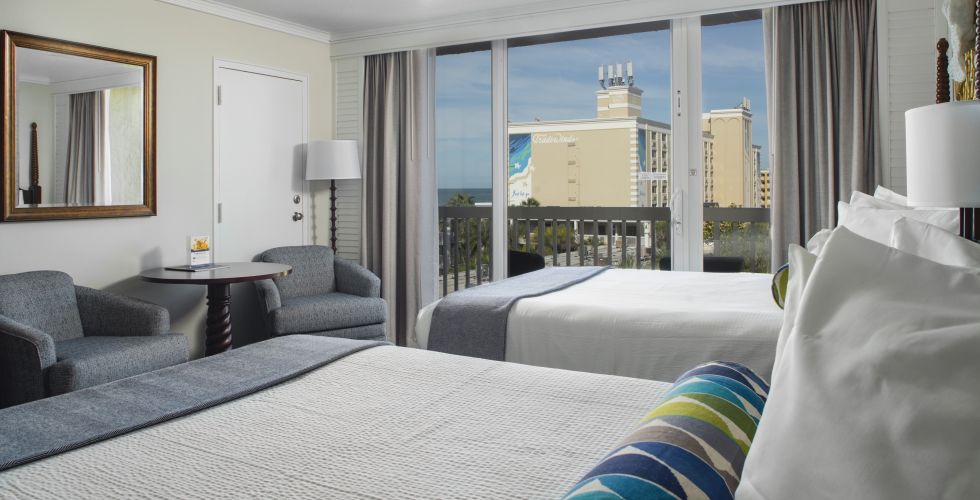 A Bedroom With A Large Bed In A Hotel Room