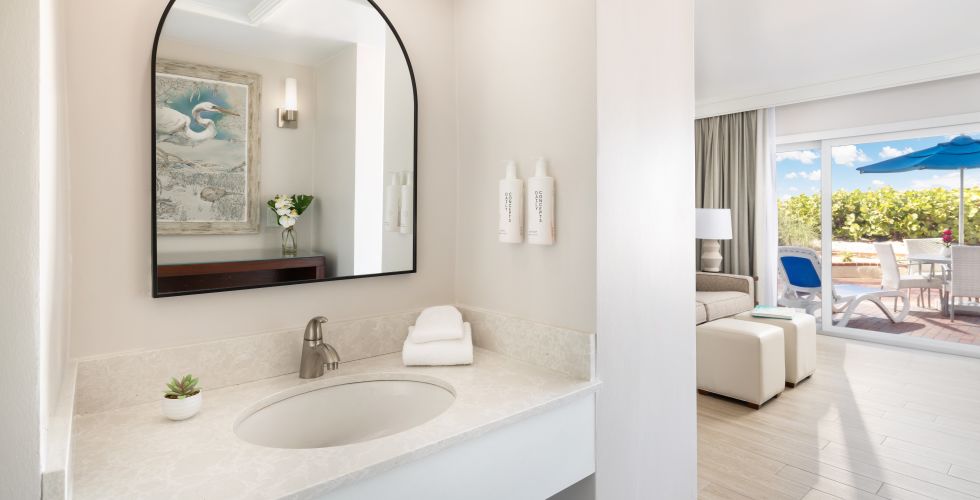 A Bathroom With A Large Mirror