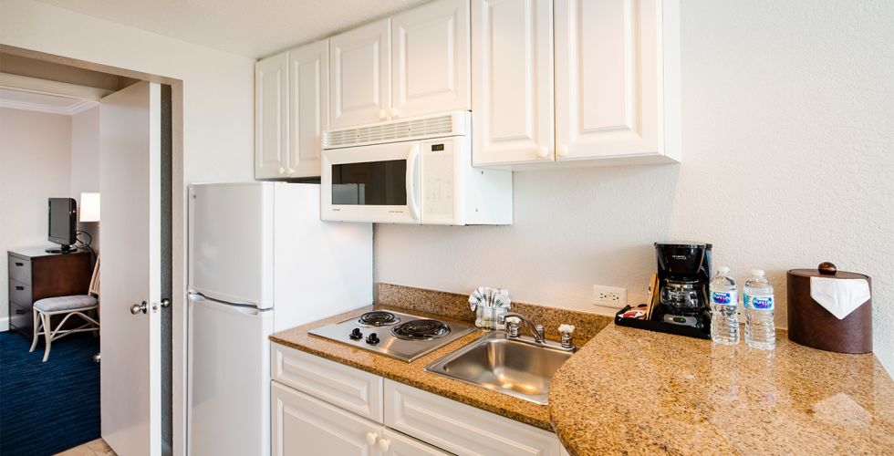 A Kitchen With A Sink And A Refrigerator