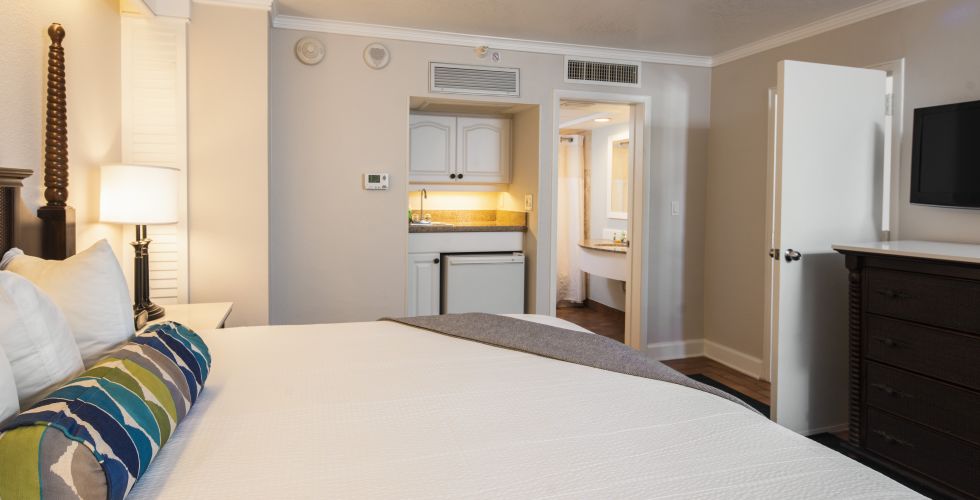 A Bedroom With A Bed And A Television