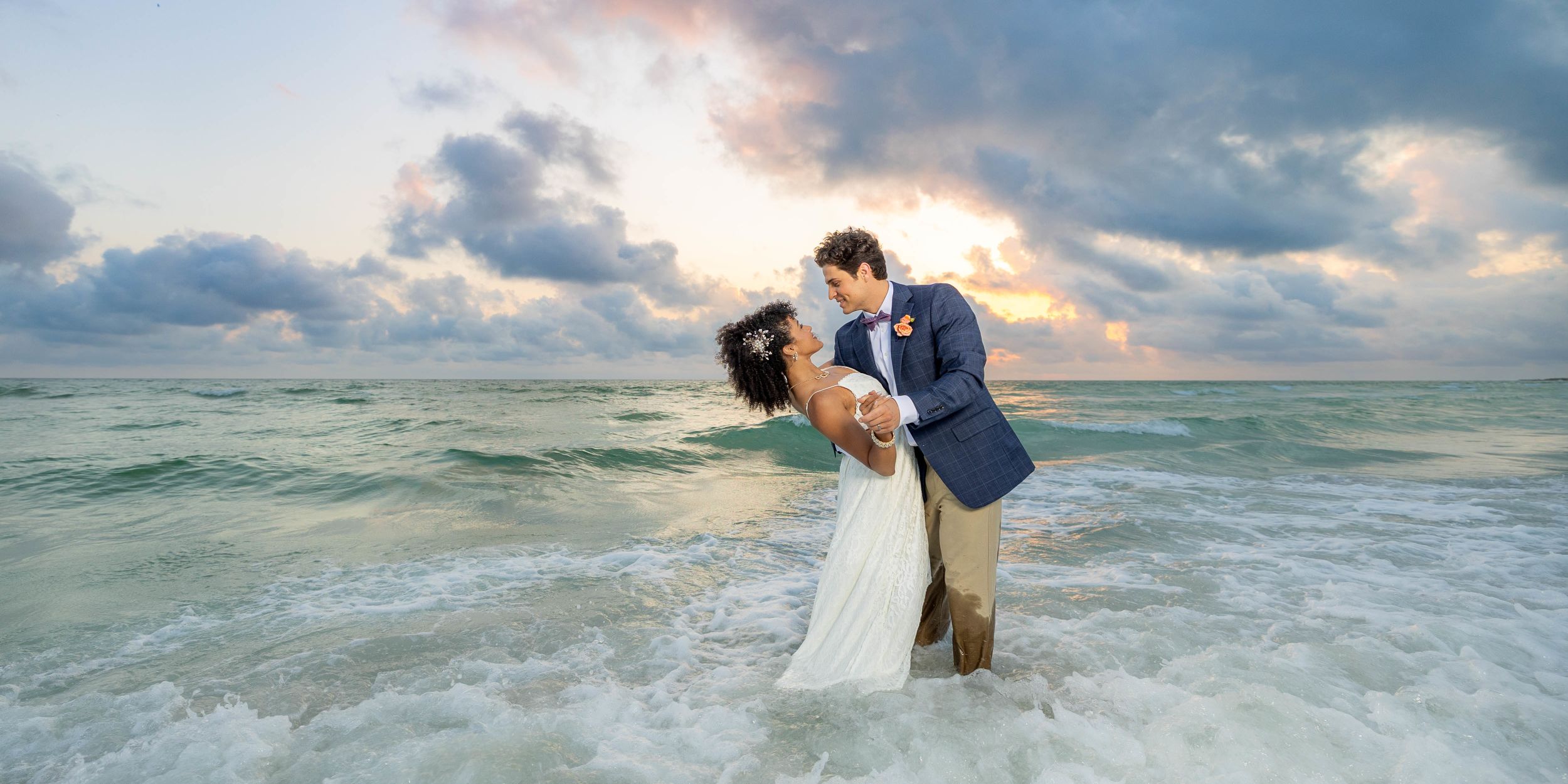 A Man And Woman Kissing In The Water