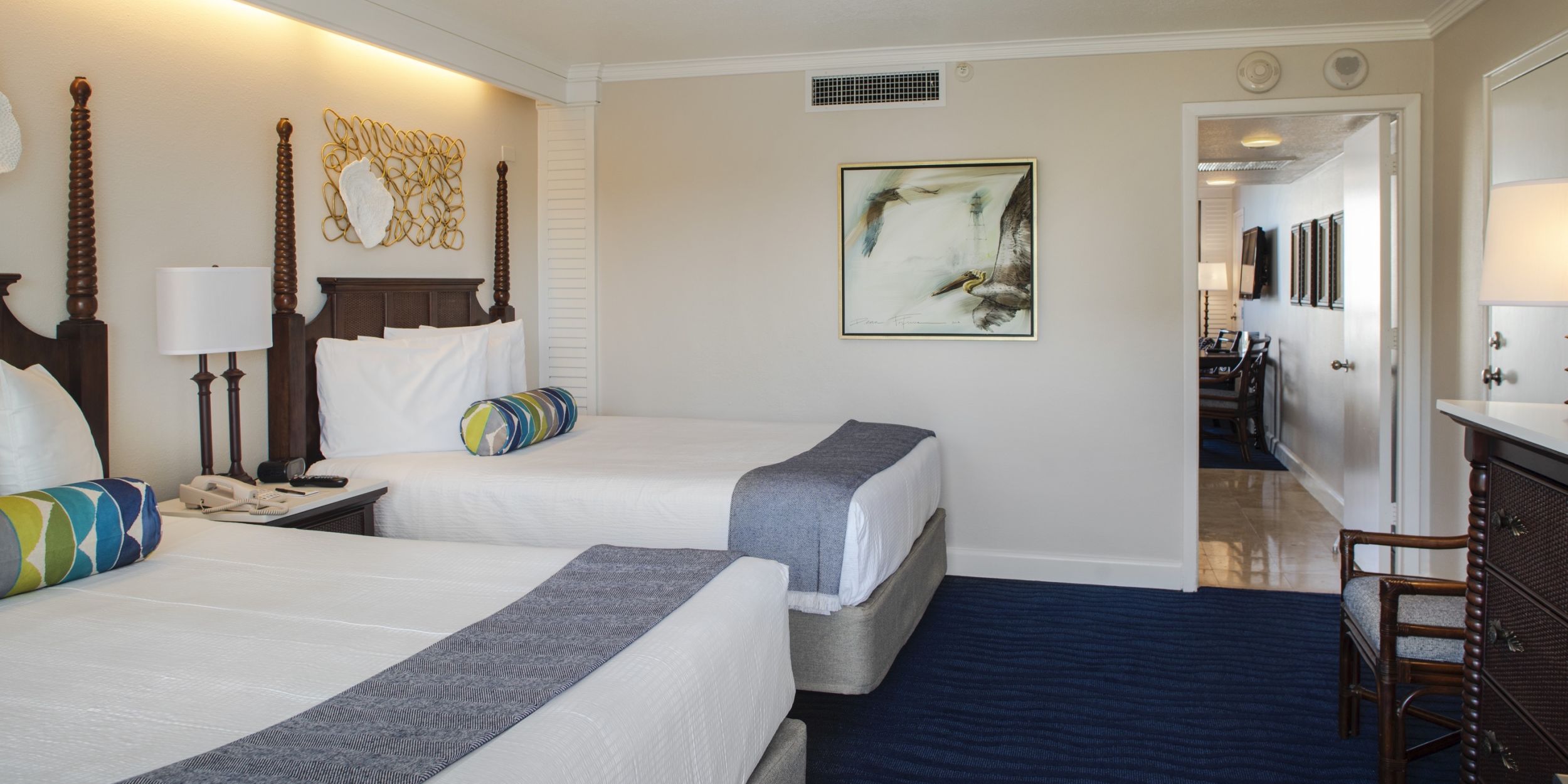 A Bedroom With A Bed And A Chair In A Room