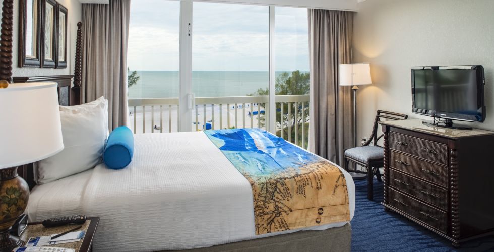 A Hotel Room Filled With Furniture And A Large Window