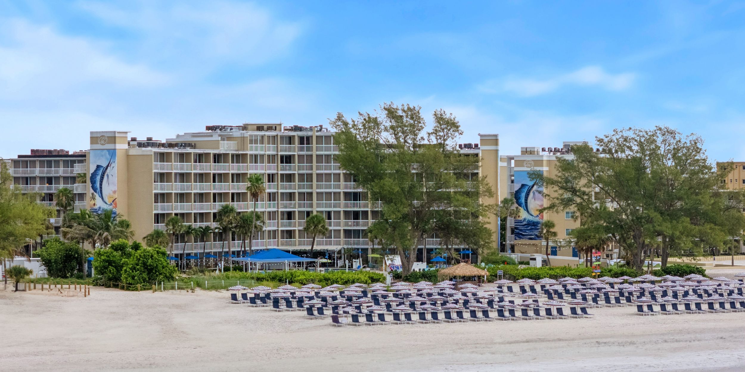 A Beach With Buildings And Trees