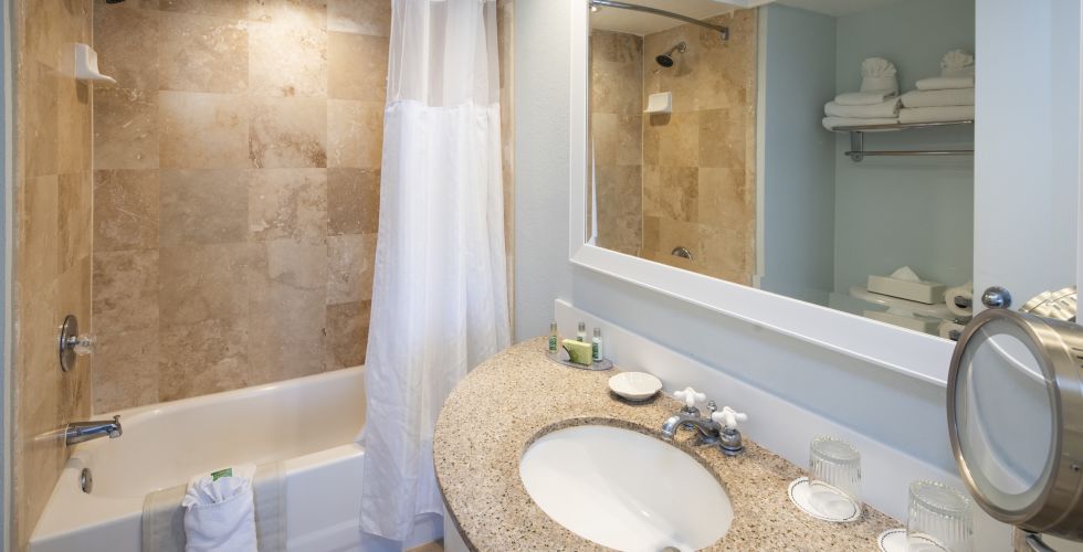 A Room With A Sink And A Mirror