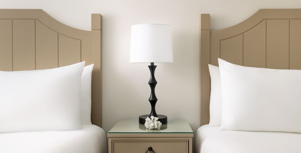 A Room With A Bed And A Lamp