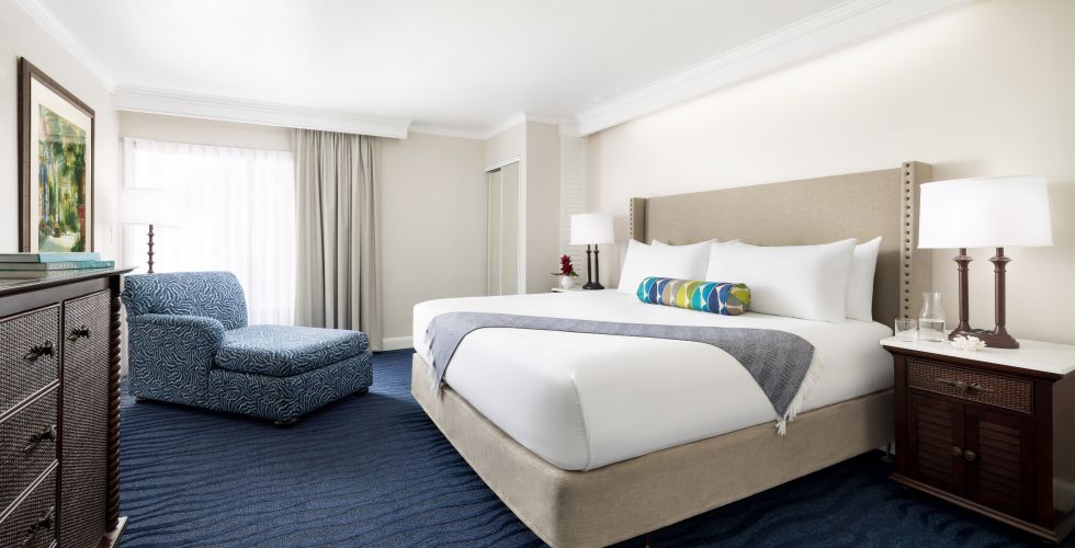 A Bedroom With A Bed And A Chair