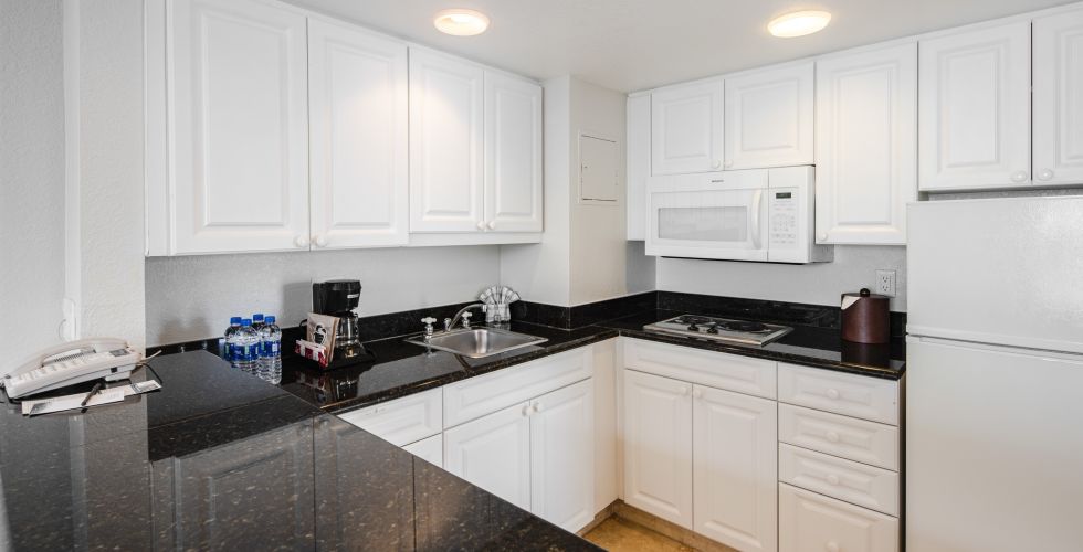A Kitchen With A Sink And A Refrigerator