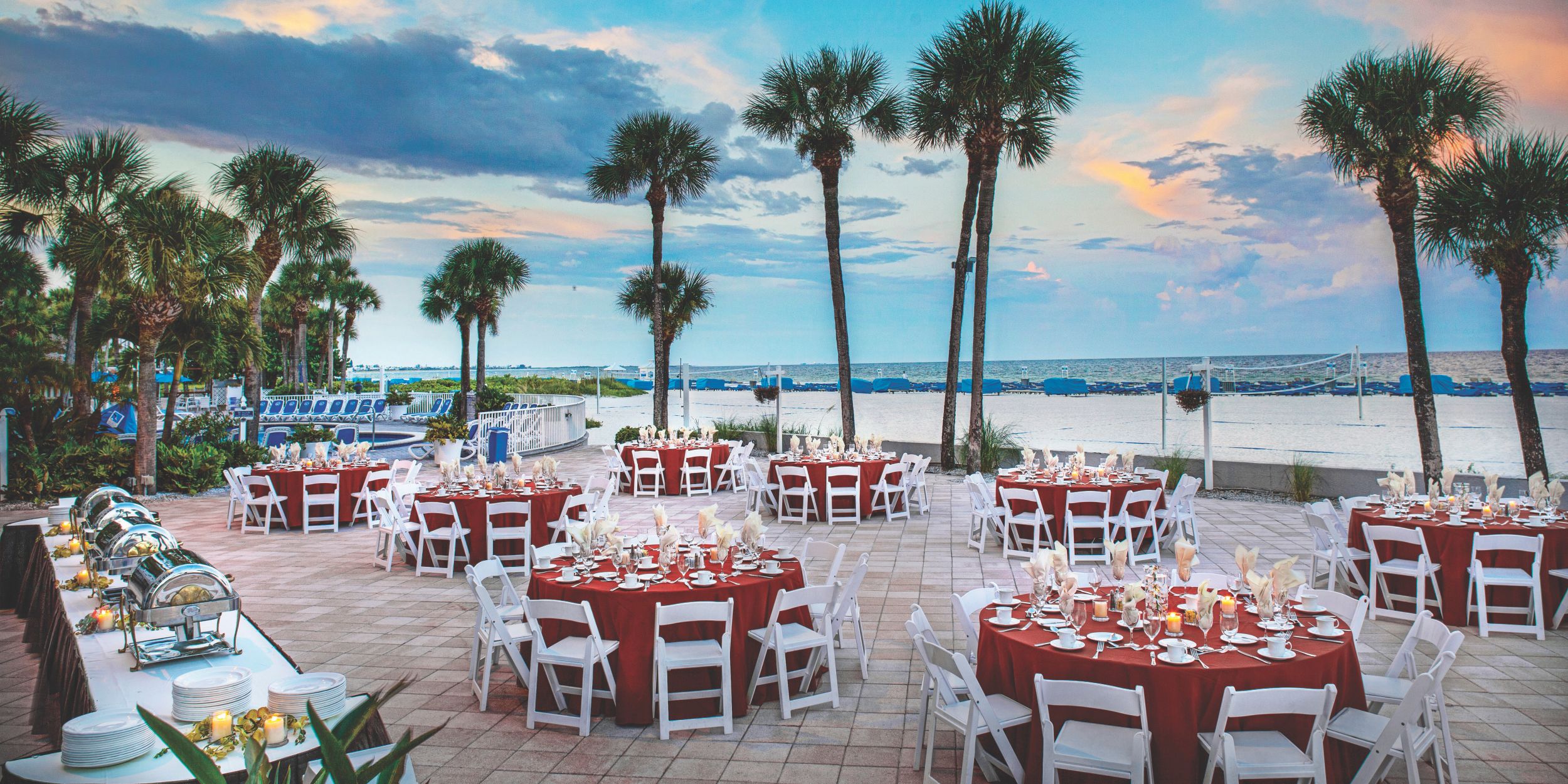 A Group Of Lawn Chairs Sitting On Top Of A Sandy Beach