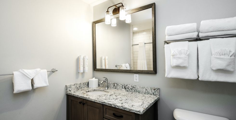 A Bathroom With A Large Mirror