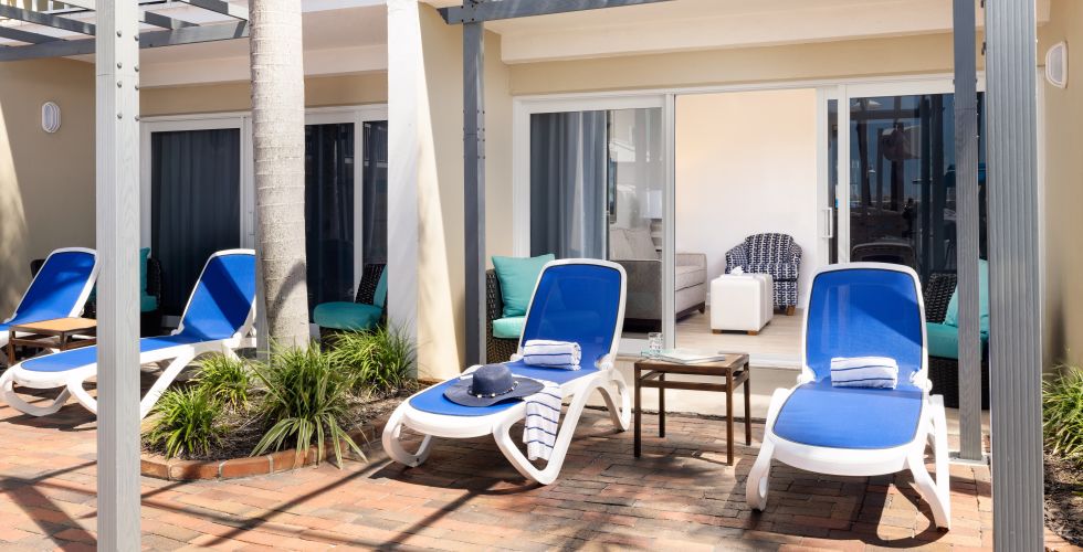 A Patio With Chairs And A Bike