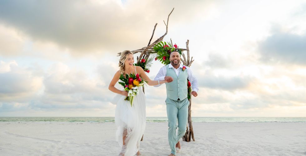 A Man And Woman Walking On A Beach