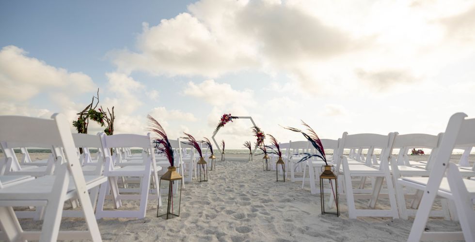 A Group Of White Chairs On A Beach