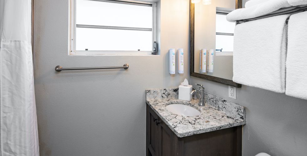 A Bathroom With A Sink And A Mirror