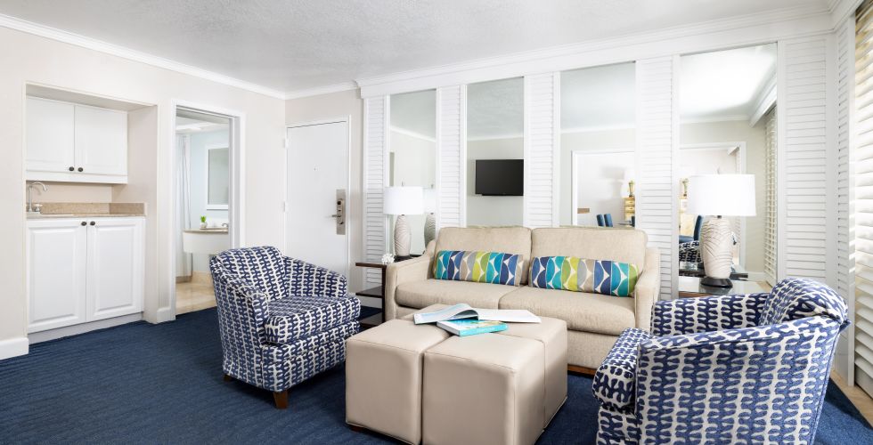 A Room With A Couch And Chairs