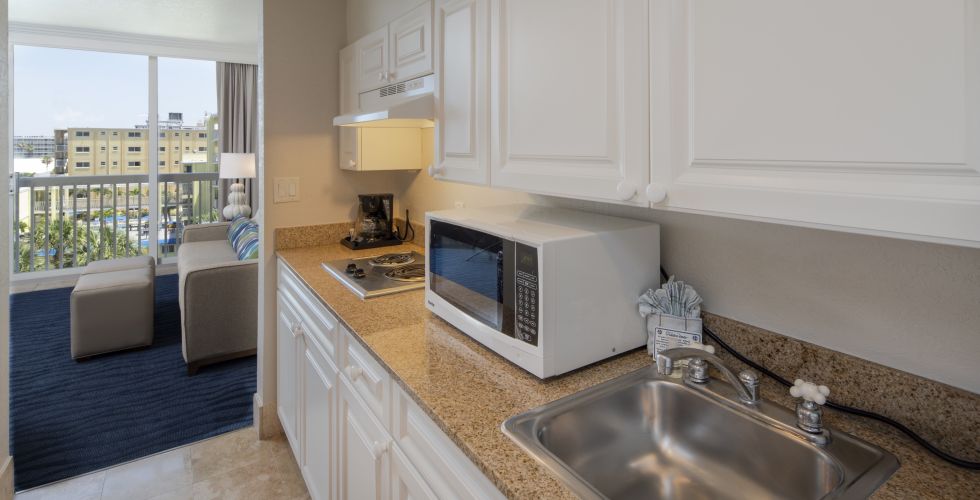 A Kitchen With A Sink And A Mirror