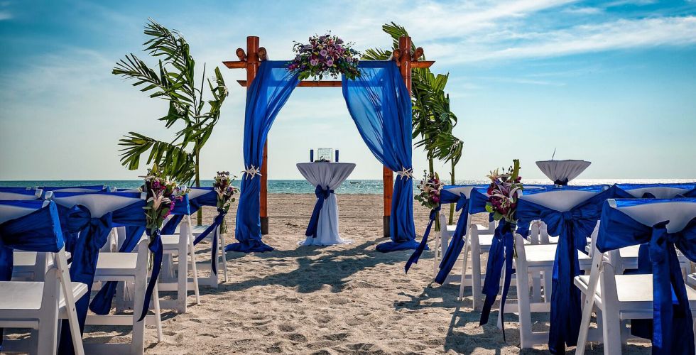 A Group Of People Sitting At A Beach