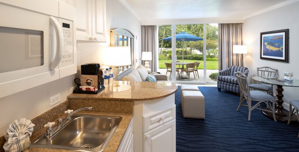 A Kitchen With A Stove Top Oven Sitting Next To A Window