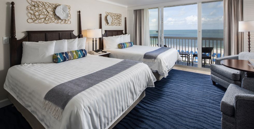 A Bedroom With A Large Bed In A Hotel Room