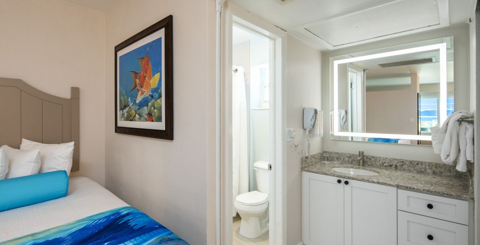 A Bathroom With A Bed And A Sink