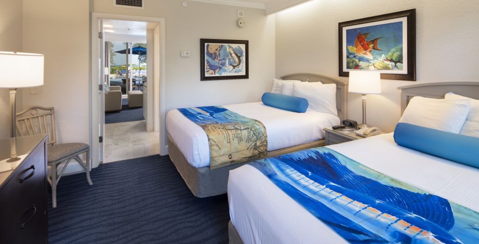 A Bedroom With A Bed And Desk In A Room